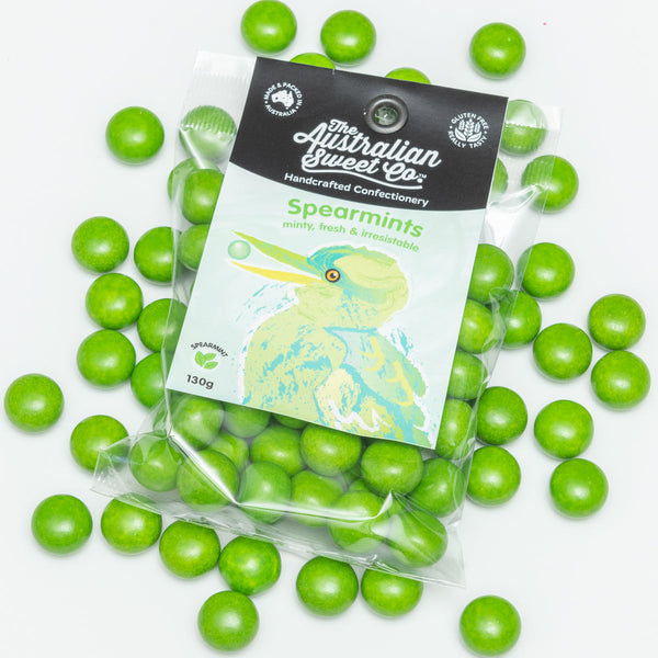 Green spearmint candies with a transparent packaging bag featuring branding on a white background.